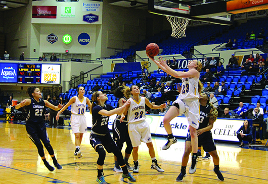 Rising above the rest, Kelsey Fitzgerald, a senior forward from Yankton, South Dakota, goes in for a layup.  
