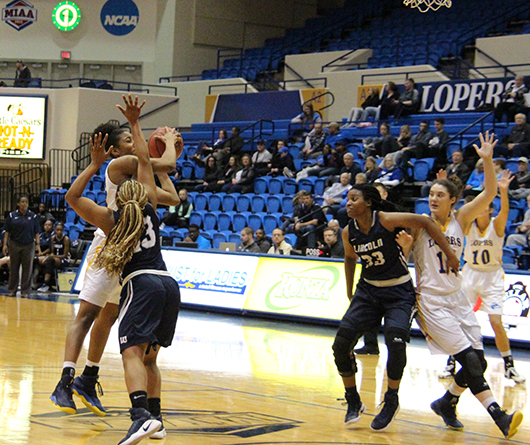Struggling for the ball, Imani Kyser, a junior forward from Alabama tries to make the basket.