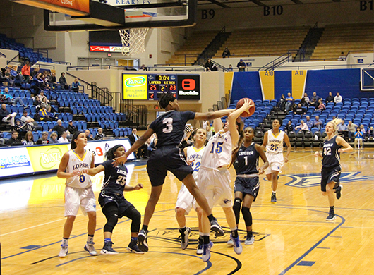 Going in for the shot, freshman point guard Grace Barry, from Lincoln, fights to make the basket.