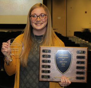 Ivy Prater, president of the Alpha Phi sorority, holds with the award given to the sorority for having the highest GPA among sororities.