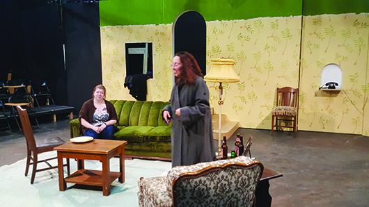 Freshman theatre major Tiffany Hall of North Platte speaks to senior psychology major Mikayla Stephenson from Scottsbluff. Hall plays an aging mother named Bella McCorkle, and is comforted in this scene by her longtime friend Jessie, played by Stephenson.
