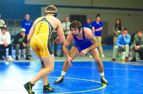 Photo by Todd Rundstrom Senior Destin McCauley eyes his opponet during a recent match at Cushing Colesium. The Physical Education K-6 major from North Sioux City, IA has found success in wrestling at many levels, including here at UNK.