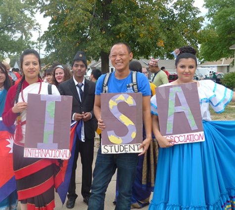 Photo by Daniela Gonzalez I.S.A. members Uppalavanna Shakya, an advertisement and public relations major from Nepal; Show Takei, an aviation major from Japan; and Ana Rodriguez, Lexington, carry ISA posters during the 2016 welcome parade in downtown Kearney.