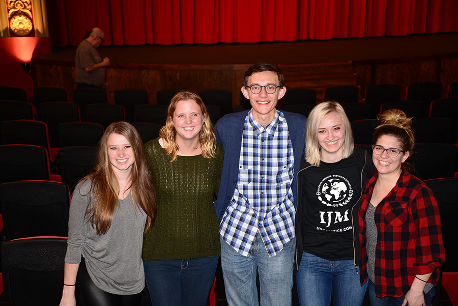 Jase Hueser (middle) stands with other IJM members in the World Theatre after the showing of the film, “The Whistleblower.” Also pictured: Andrianna Meyer, Jessa Schultis, Jase Hueser, Isabella Lohmeyer and far right, Madeleine Soucie.