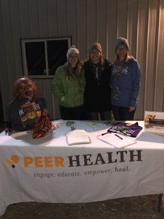 From left to right, Alaini Priebe, Brittany Hanzlik and Samantha Horne, members of UNK Peer Health, volunteered in the Ok’SOBER’fest event at KneeKnocker Woods.