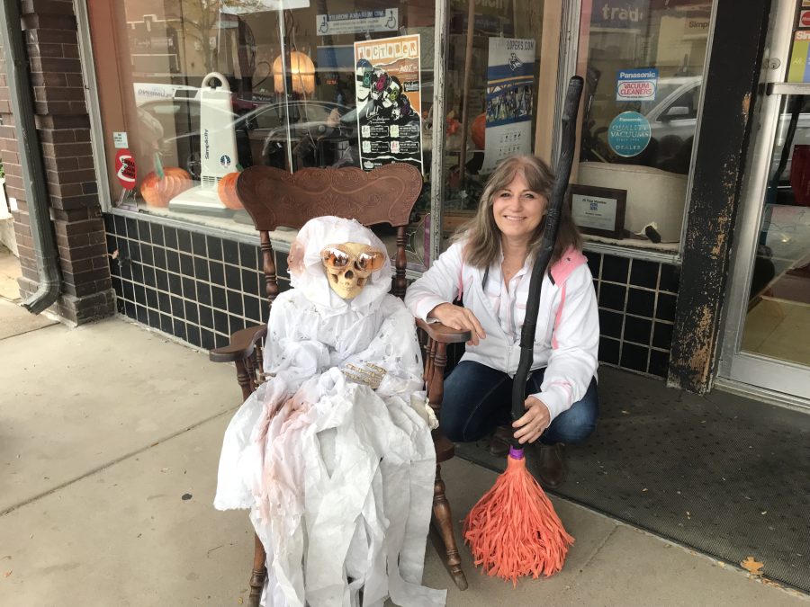 Alice Buser of Kearney Center Vacuum poses outside of the locally owned business for a quick break before handing out candy for another hour to kids.