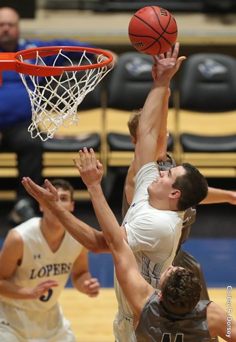 Koster drives to the hoop on a pick and roll play as he draws a foul from his opponent. The true freshman currently leads the Lopers in points, rebounds and assists. UNK looks to build around Koster as one of their core players.