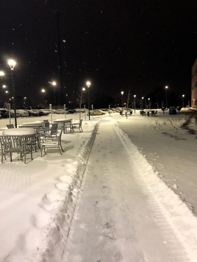 Photo of a sidewalk on campus that is snowy