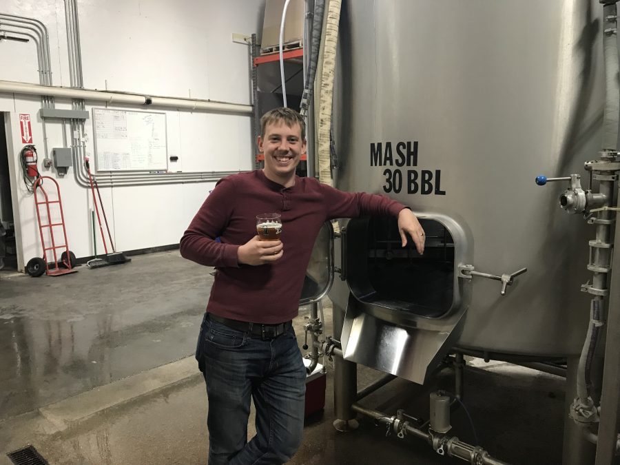 Dave+Schaben%2C+head+of+tours+and+son+of+co-owner+of+Thunderhead+Brewery%2C+stands+in+front+of+the+masher+in+the+warehouse+at+the+Thunderhead+Brewery+location+in+Axtell%2C+Nebraska.