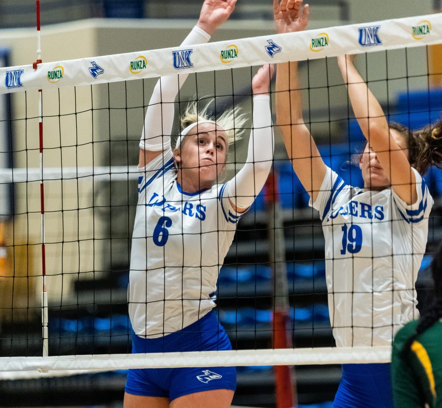 Maddi Squiers and Michaela Bartels go for a block at the net against Rockhurst. The Lopers won three sets to one