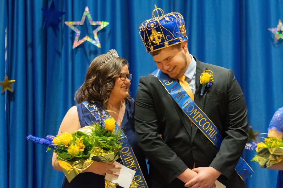 Mackenzie Petersen (left) and Jacob Roth (right) stand as they get crowned as homecoming royalty