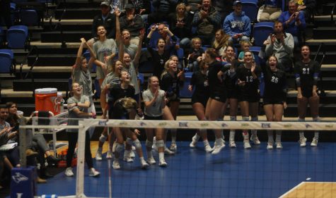 UNK volleyball bench celebrating
