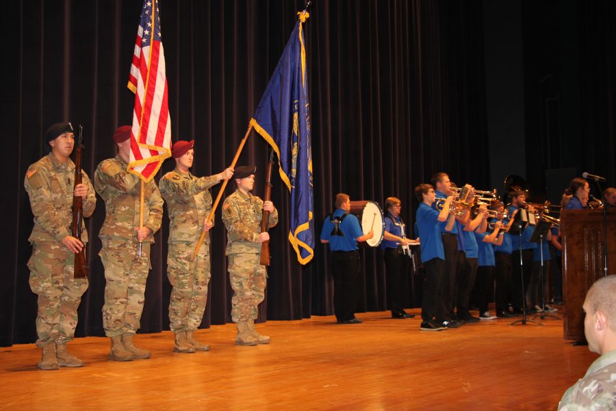 During+the+Veteran%E2%80%99s+Day+event%2C+the+color+guard+stands+at+attention+as+the+band+plays+the+National+Anthem.