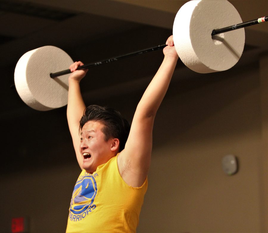 Eiji+Oishi+demonstrates+weight+lifting%2C+a+popular+event+at+the+TOKYO+Olympics.