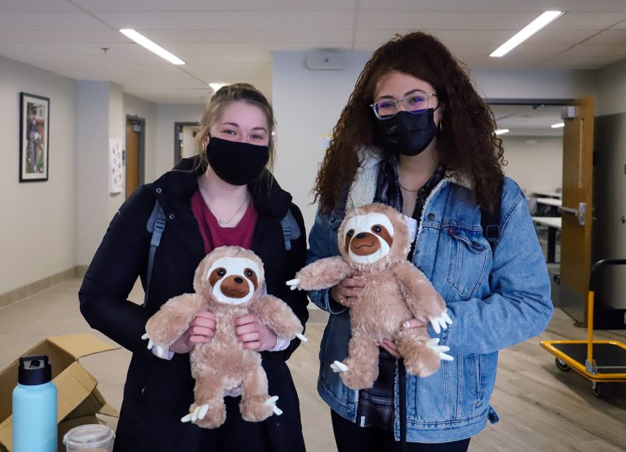Madeline Riesberg (left) and Emily Saadi (right) show off their sloths.