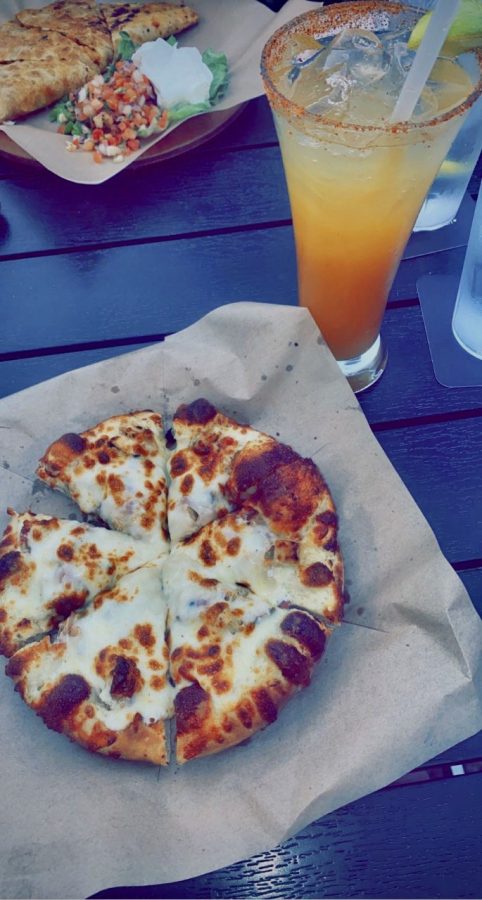 Popular menu items include the chicken bacon ranch pizza and the pineapple mango margarita.
