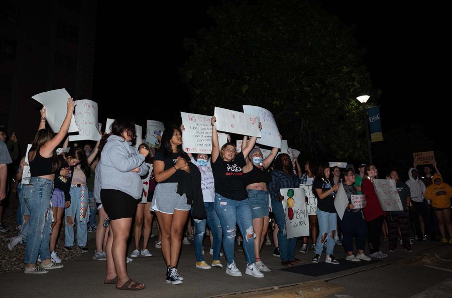 Demonstrators use signs to stress the point of listening to those affected by sexual assault.