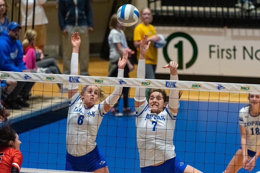 Maddie (left) and Anna Squiers (right) team up to block an attack attempt.