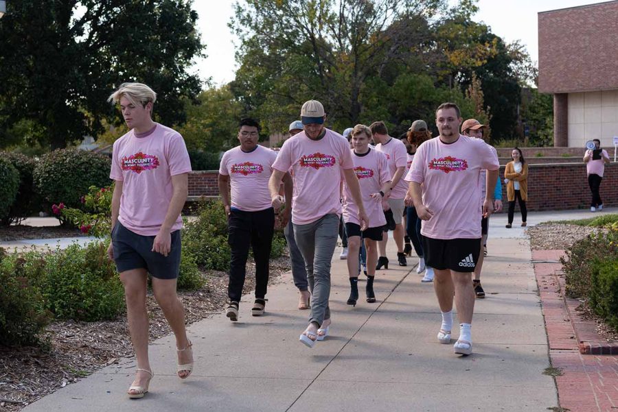 Kieren Feeney leads a pack of men marching for Domestic Violence Awareness Month.