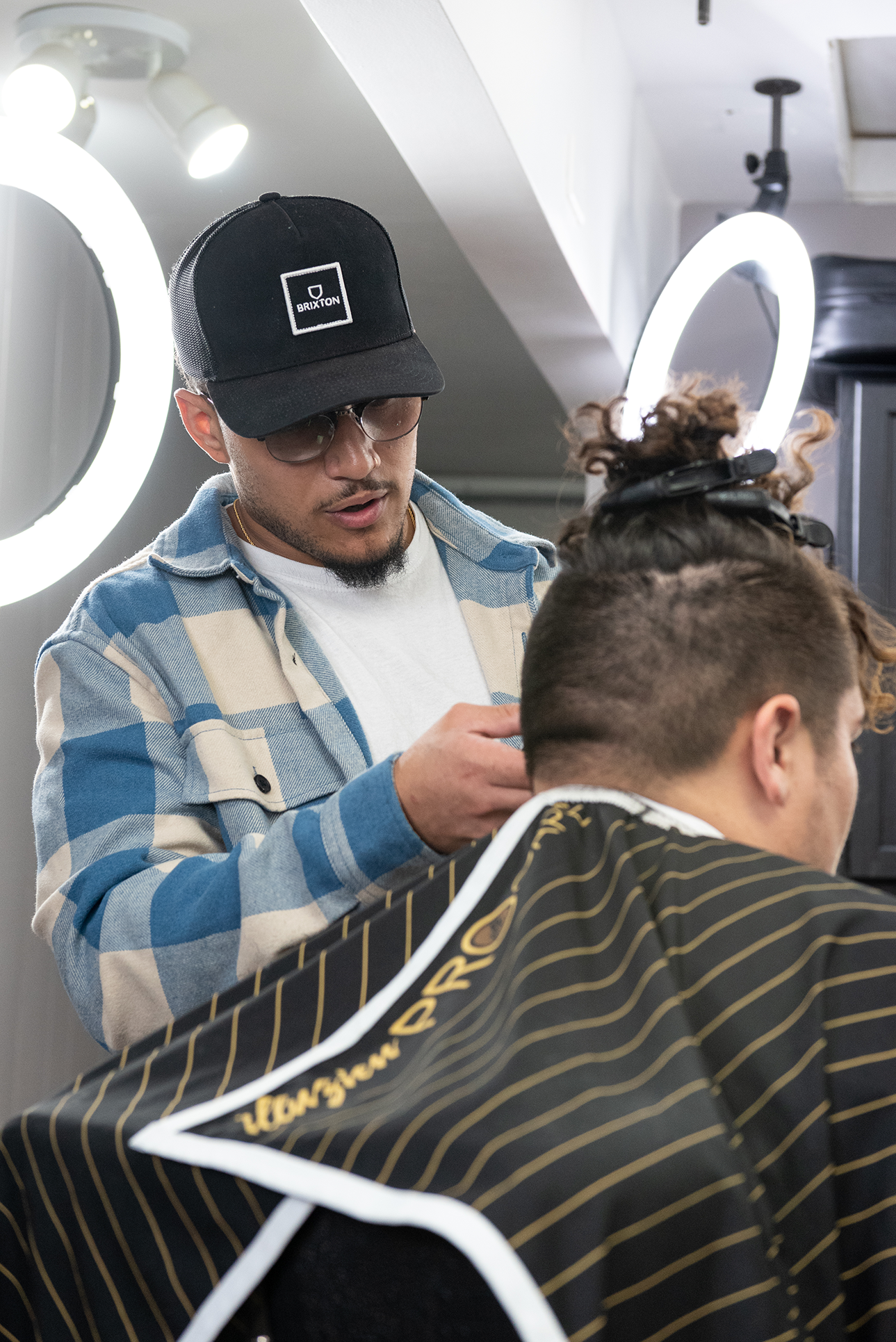 Terry Perry styles students hair at Relentless Barber Studio.
