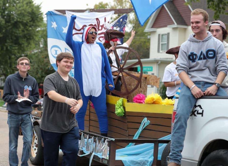 Michael Frandolig rides a parade float with his fraternity. Courtesy Photo
