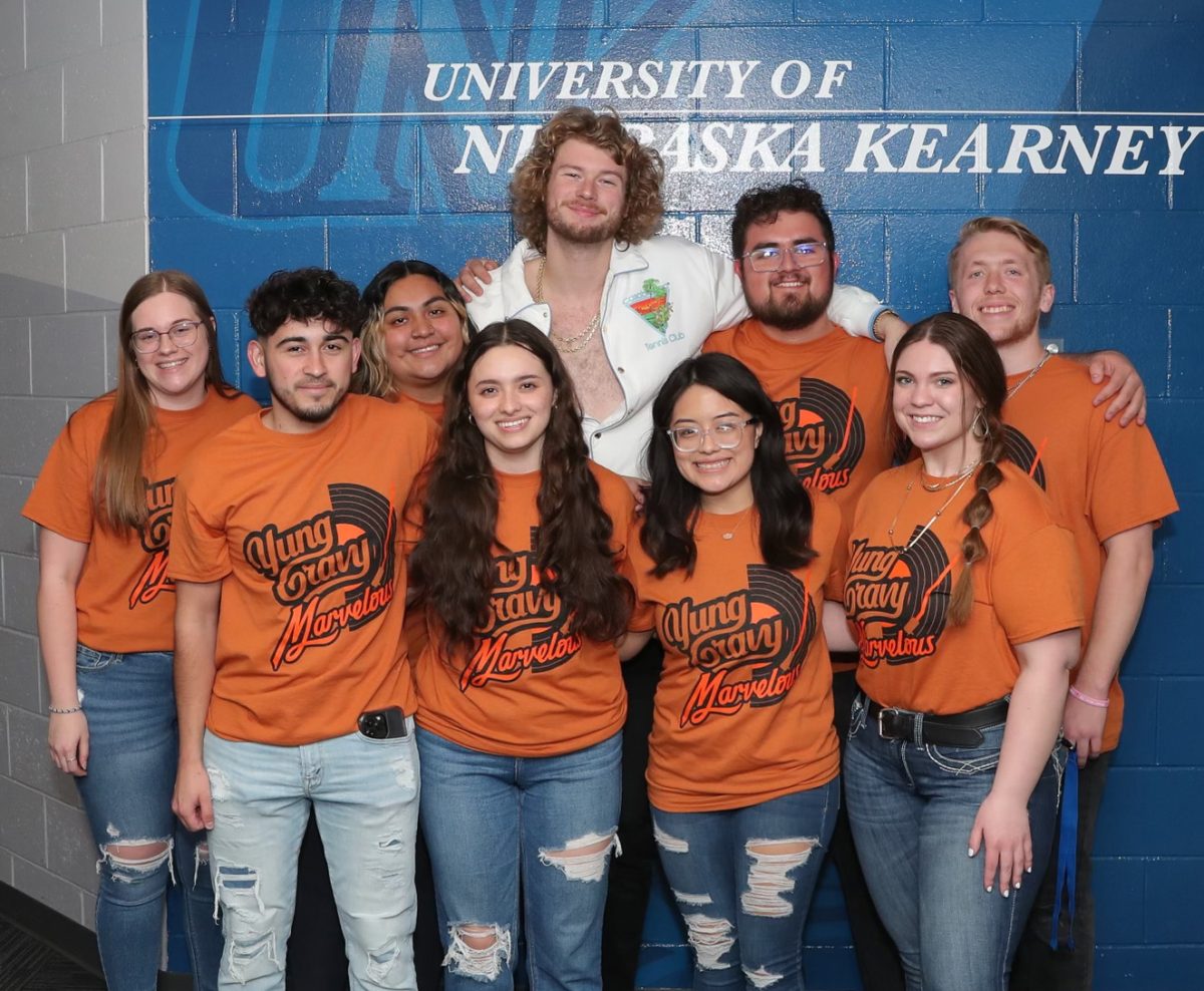 Carolyn Zamora, bottom center, poses with Yung Gravy and other UNK students last spring. Photo by Maisy Wade / Antelope Staff