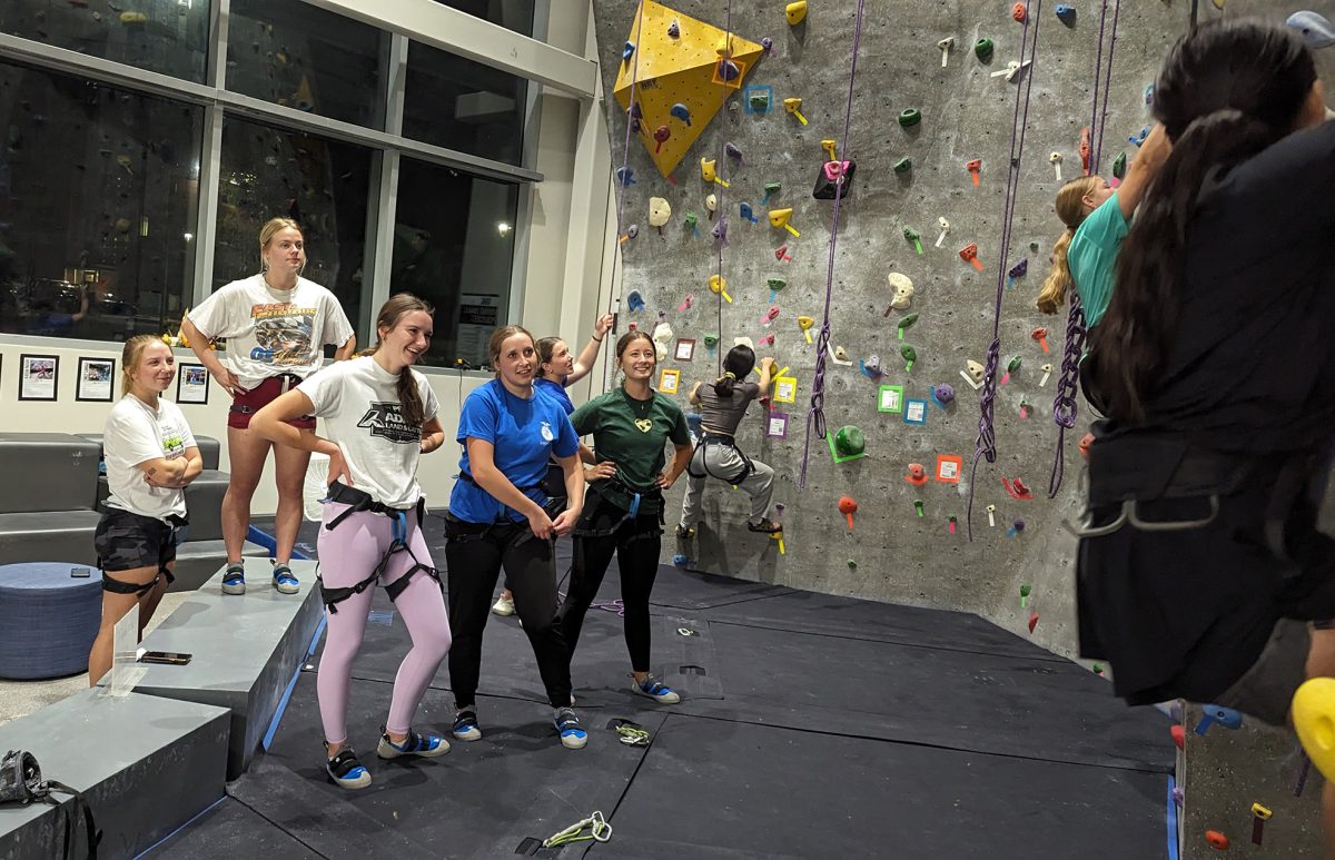 Fellow climbers cheer on their peers during their climbs. Photo by Lucas Ratliff / Antelope Staff