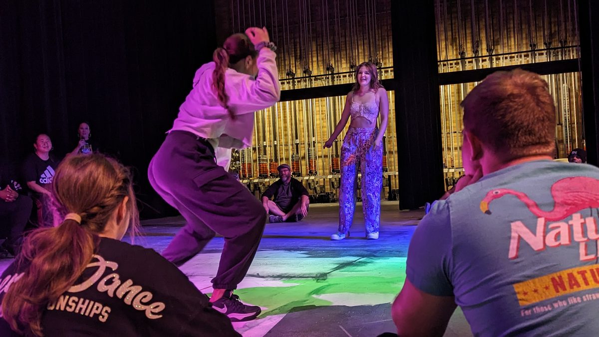 Maria Klingelhoefer faces Emma Jahn in a dance-off on the Drake Theater stage. Photo by Lucas Ratliff / Antelope Staff