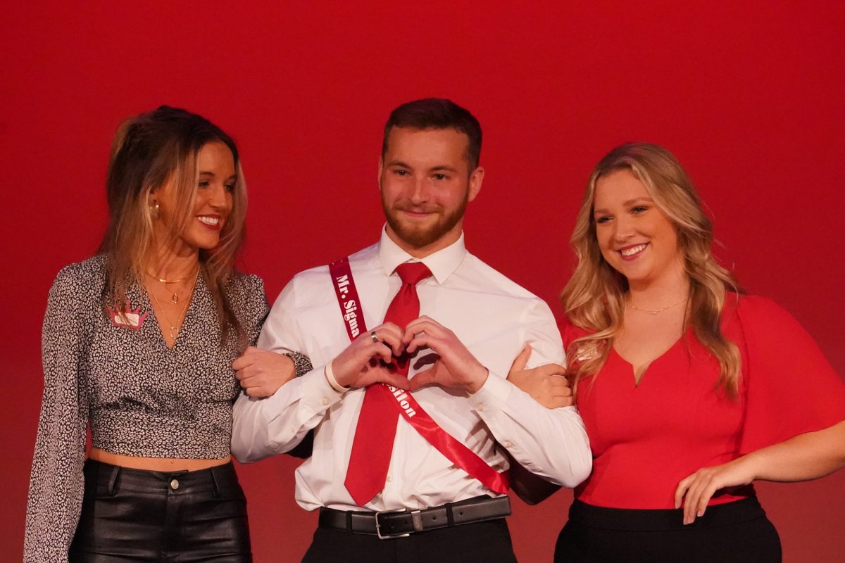 Luke Przymus is crowned Mr. King of Hearts, escorted by Jade Vak and Cali Erickson. Photo by Shelby Berglund / Antelope Staff