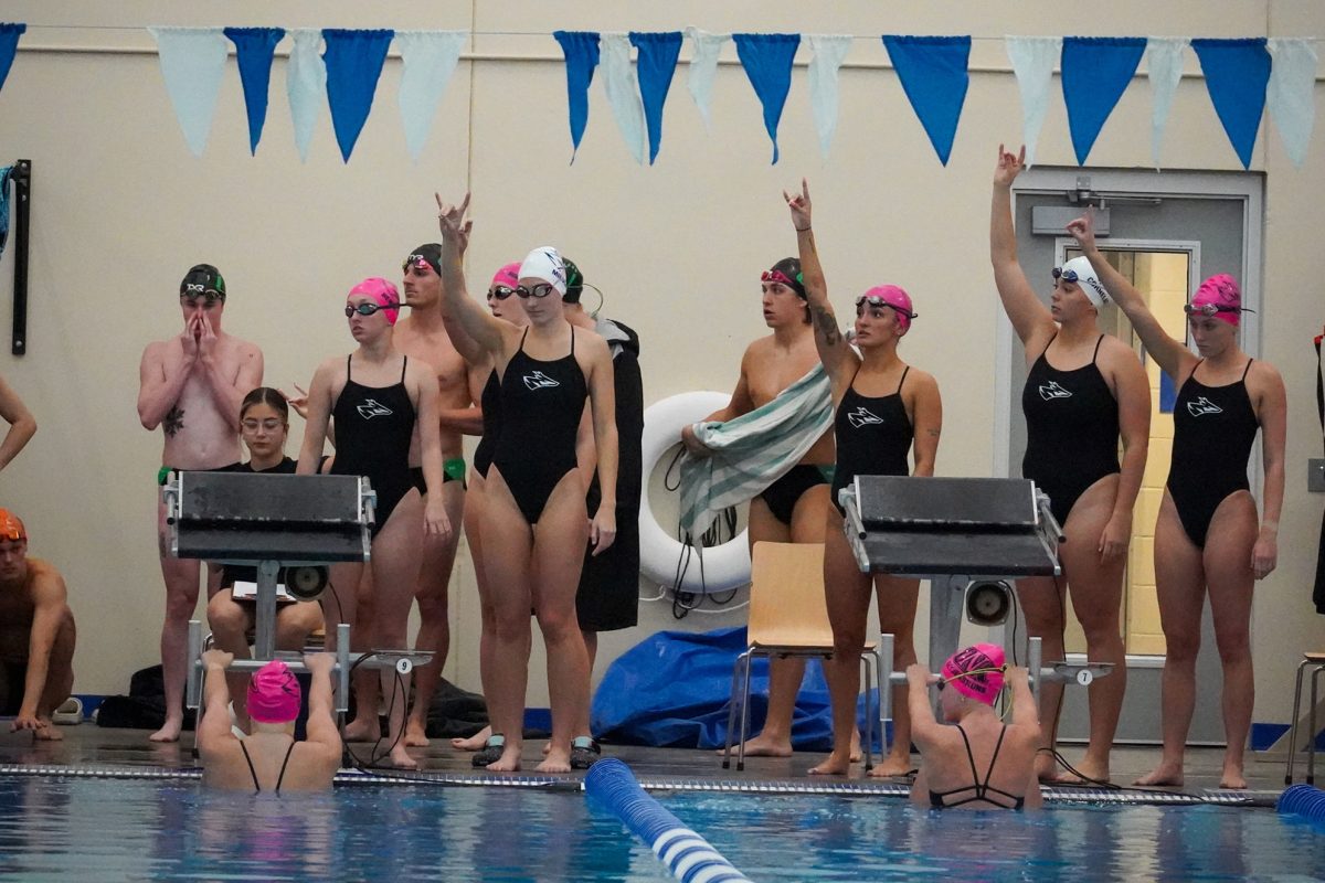Members of the UNK swimming and diving team throw their Lopes during their home meet. Photo by Shelby Berglund / Antelope Staff 