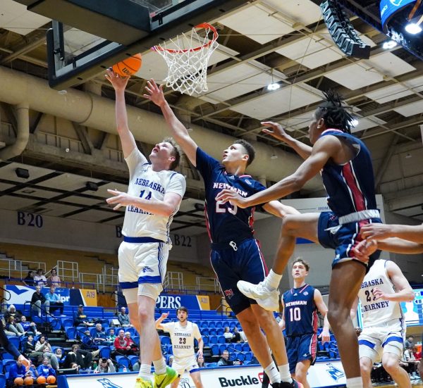 UNKs Winston Cook uses the glass on a contested layup during the Lopers home game against Newman this season. Photo by Shelby Berglund / Antelope Staff