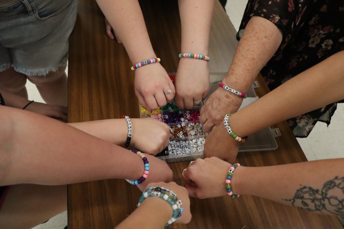 Students gather together with their friendship bracelets at TRIOTA's event, promoting suicide prevention awareness. Photo by Gabby Roche / Antelope Staff