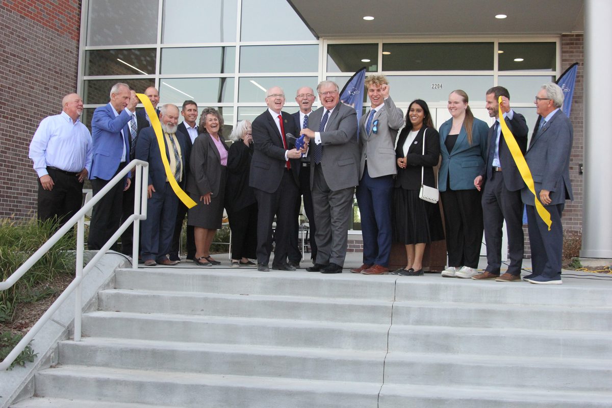 Jeffrey Gold, University of president, and Doug Kristensen, UNK's previous chancellor, cut the ribbon for the center. Photo by Jenju Peters / Antelope Staff