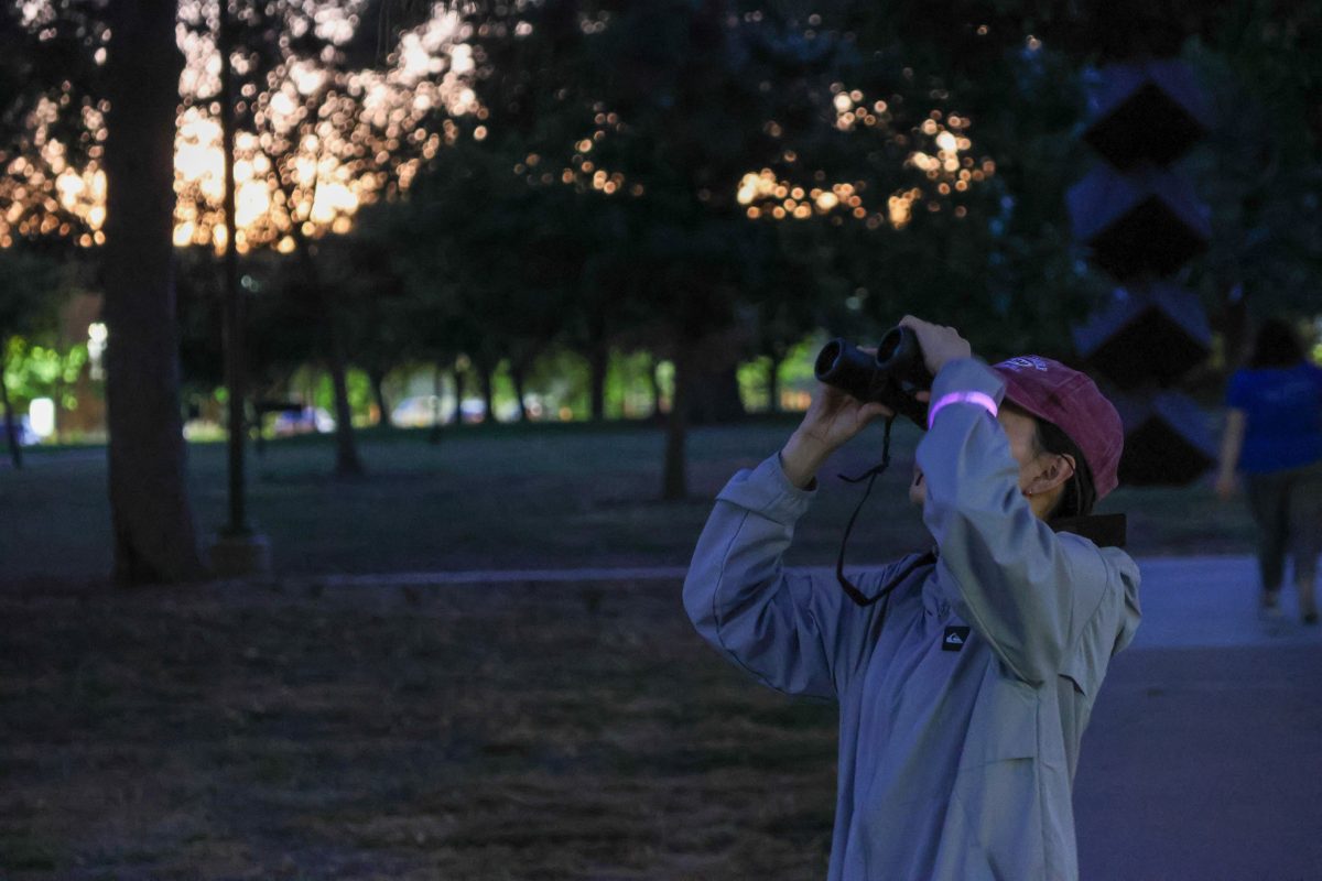 Grace Park searches for stars, planets and constellation illuminating the night sky. Photo by Jenna Heinz / Antelope Staff