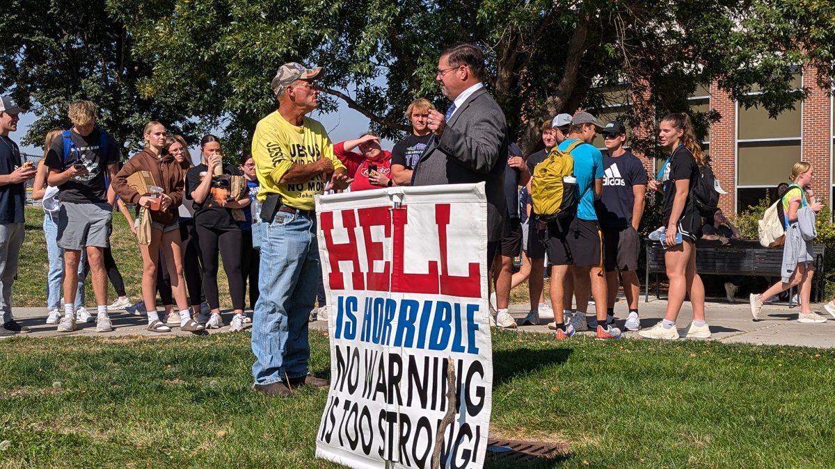 Matt Bourgault is approached by John Falconer, senior advisor to the chancellor, and asked to remove his sign. Photo by Lucas Ratliff / Antelope Staff