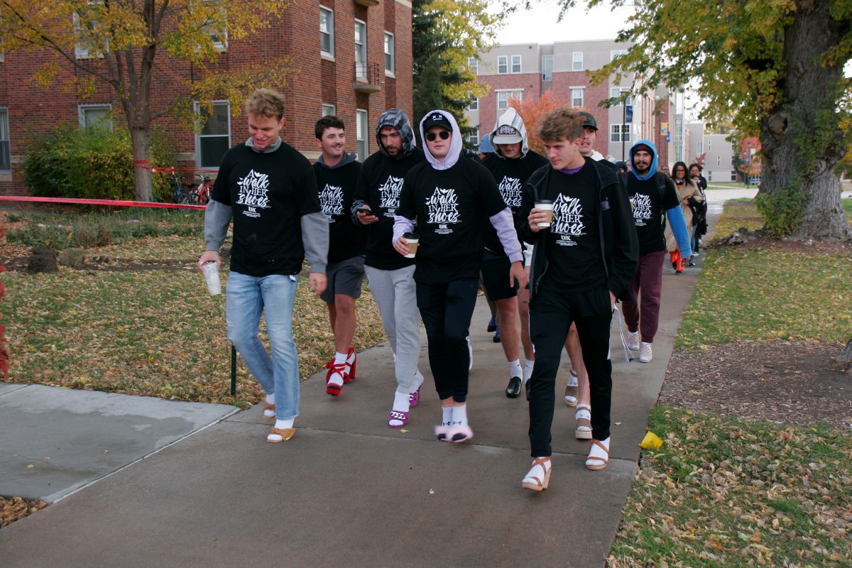 Sam Schroeder, Alex Abels, Zane Grizzle, Levi Powell and Travis Meyer walk in support of gender-based violence. Photo by Travianna Tighe / Antelope Staff