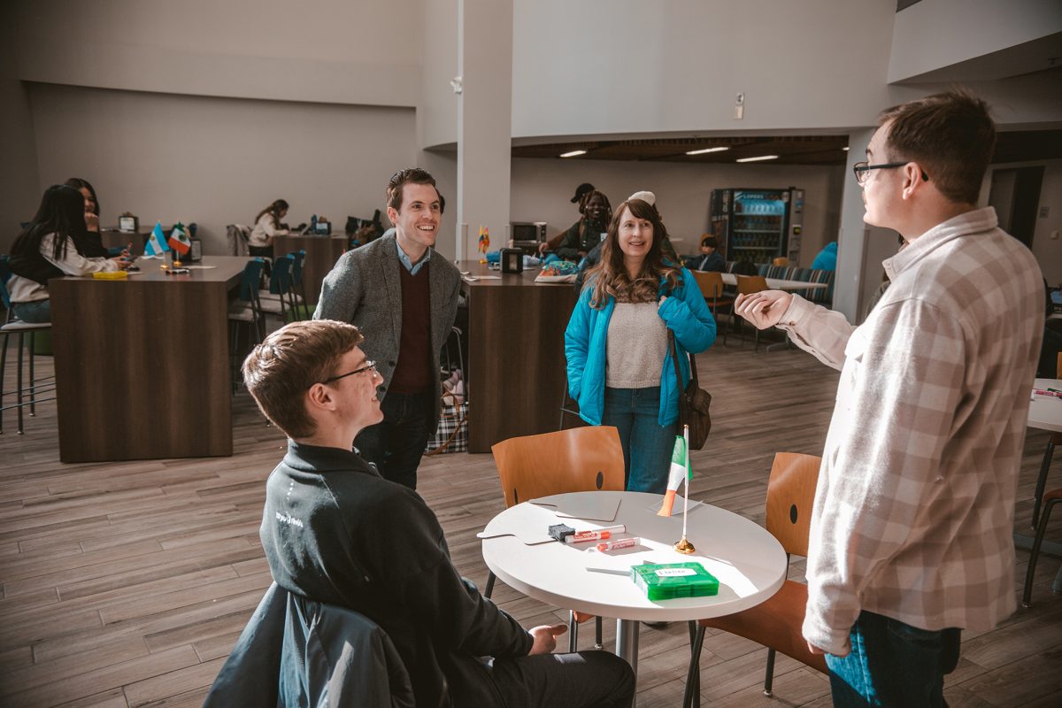 Carter Cochran, Chris Jacobs, Jayne Heimer and John Mulholland have a five-minute speaking lesson at the Italian language table. Photo by Micah Torres / Antelope Staff