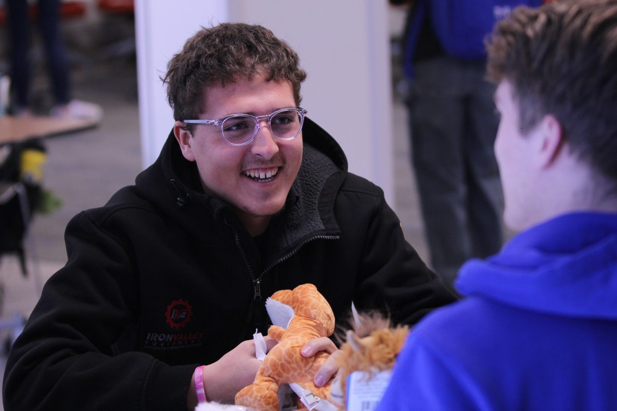 Jordan Peglow stuffs a dinosaur plush at the Loper Programming and Activities Council's annual stuff-a-plush event. Photo by Preston Larson / Antelope Staff