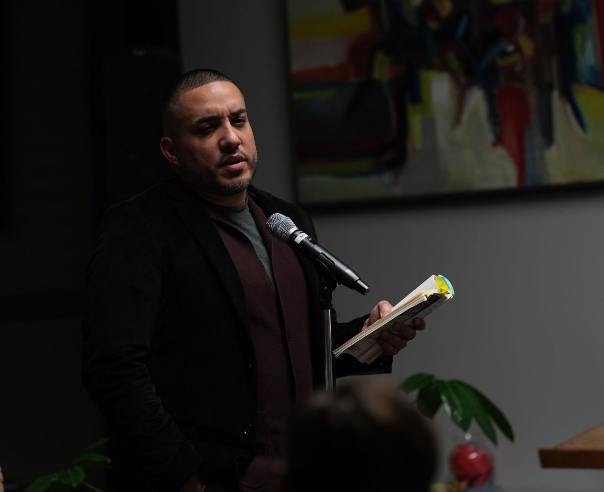 Poet Huascar Medina shares his work at the Visiting Writers Series poetry night. Photo by Jenju Peters / Antelope Staff